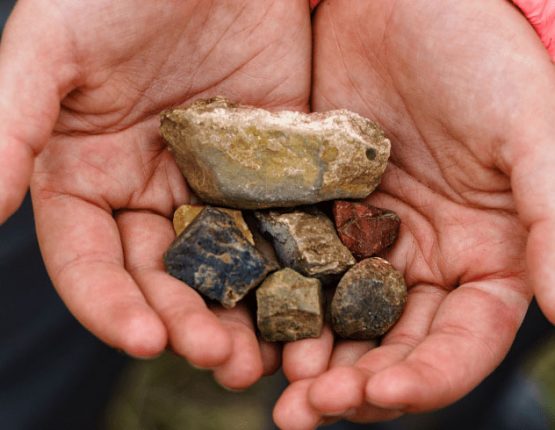 hands holding rocks